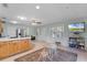 Open-concept living area with a kitchen, dining area, and TV for entertaining at 16692 Lake Pickett Rd, Orlando, FL 32820