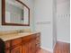Bathroom features a wooden vanity with decorative mirror, updated sink and fixtures at 1702 N Westmoreland Dr, Orlando, FL 32804