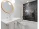 Stylish bathroom boasts a modern pedestal sink and tiled shower/tub combination at 1702 N Westmoreland Dr, Orlando, FL 32804