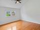 This bedroom features hardwood floors and a large window, creating a bright and inviting space at 1702 N Westmoreland Dr, Orlando, FL 32804