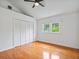 Cozy bedroom with hardwood floors and closet featuring bright natural light through the window at 1702 N Westmoreland Dr, Orlando, FL 32804