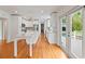 Modern kitchen with white cabinetry, quartz countertops, stainless steel appliances, and hardwood flooring at 1702 N Westmoreland Dr, Orlando, FL 32804