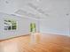 Bright living room features hardwood floors, recessed lighting, modern ceiling, and glass doors to the backyard at 1702 N Westmoreland Dr, Orlando, FL 32804