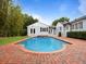 Stunning pool, lush landscaping, and architecture create a serene and private backyard retreat at 1702 N Westmoreland Dr, Orlando, FL 32804