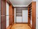 Large walk-in closet featuring custom built-in shelving and wood floors, perfect for organization at 1702 N Westmoreland Dr, Orlando, FL 32804