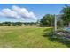 Expansive backyard backing to a golf course with mature trees and lush green grass at 1851 Sweetwater West Cir, Apopka, FL 32712