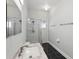 Bright bathroom features a shower with glass enclosure, modern vanity, and black tiled floors at 1851 Sweetwater West Cir, Apopka, FL 32712