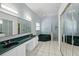 Large bathroom offers and sinks, white tile floors, granite counters, and a green tiled tub at 1851 Sweetwater West Cir, Apopka, FL 32712