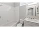 Bathroom offers a shower/tub combination with white vanity, mirror, and a glass-block window at 1851 Sweetwater West Cir, Apopka, FL 32712