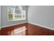 Bright bedroom with hardwood floors, large window, and neutral paint, a relaxing retreat at 1851 Sweetwater West Cir, Apopka, FL 32712