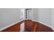 Bedroom features hardwood floors, closet with shelving, and a window with blinds at 1851 Sweetwater West Cir, Apopka, FL 32712