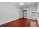 Bright bedroom features wood floors, large window, closet, and ceiling fan at 1851 Sweetwater West Cir, Apopka, FL 32712