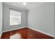 Bedroom with hardwood floors and white walls offers a minimalist and modern feel at 1851 Sweetwater West Cir, Apopka, FL 32712