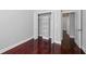 Bedroom offers hardwood floors, white trim, and a closet with adjustable shelving at 1851 Sweetwater West Cir, Apopka, FL 32712