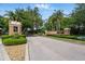 Gated community entrance showcasing the professionally maintained landscaping at Sweetwater West at 1851 Sweetwater West Cir, Apopka, FL 32712