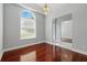 Dining area featuring wood floors, an elegant chandelier and a transom window at 1851 Sweetwater West Cir, Apopka, FL 32712