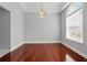 Dining area features hardwood floors, a modern chandelier, and lots of natural light at 1851 Sweetwater West Cir, Apopka, FL 32712