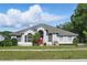 Inviting front exterior with a well-maintained lawn and colorful front door for a warm welcome at 1851 Sweetwater West Cir, Apopka, FL 32712