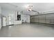Spacious garage features epoxy flooring and an automatic garage door at 1851 Sweetwater West Cir, Apopka, FL 32712