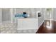 Bright kitchen with white cabinets, blue backsplash, and tiled floors at 1851 Sweetwater West Cir, Apopka, FL 32712