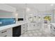 Renovated kitchen featuring quartz countertops, updated stainless appliances, and backyard view at 1851 Sweetwater West Cir, Apopka, FL 32712