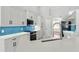 Beautiful kitchen with bright blue backsplash, quartz countertops, and new appliances at 1851 Sweetwater West Cir, Apopka, FL 32712