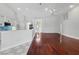 Bright open-concept living space features hardwood floors, stylish bar and modern lighting at 1851 Sweetwater West Cir, Apopka, FL 32712