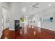 Open-concept living area with wood floors, modern fireplace, bar seating, and pool views at 1851 Sweetwater West Cir, Apopka, FL 32712