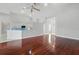 Bright, open living space featuring hardwood floors, modern lighting, and bar seating at 1851 Sweetwater West Cir, Apopka, FL 32712