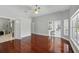 Spacious main bedroom with hardwood floors and doorway to bathroom and screened-in patio with sliding glass door at 1851 Sweetwater West Cir, Apopka, FL 32712