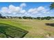 Picturesque view of the spacious open space near the home, perfect for outdoor activities and recreation at 1851 Sweetwater West Cir, Apopka, FL 32712
