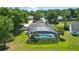 Aerial view of the sparkling pool and screened enclosure, a perfect spot for outdoor fun at 1851 Sweetwater West Cir, Apopka, FL 32712