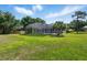 Beautiful view of the backyard pool enclosure, providing a private and relaxing oasis at 1851 Sweetwater West Cir, Apopka, FL 32712