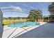 Enclosed pool area with screened-in enclosure and landscaped surroundings at 1851 Sweetwater West Cir, Apopka, FL 32712