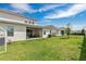 Spacious backyard with lush lawn, covered patio, and privacy fence offers outdoor enjoyment at 19334 Banfield Pl, Orlando, FL 32827