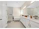 Luxurious bathroom features dual vanities, a soaking tub, and a walk-in shower with sleek, modern finishes at 19334 Banfield Pl, Orlando, FL 32827