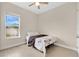 Cozy bedroom featuring a ceiling fan, neutral walls, and a view to the outdoors at 19334 Banfield Pl, Orlando, FL 32827