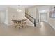 Dining room features a modern chandelier and staircase to the second floor at 19334 Banfield Pl, Orlando, FL 32827