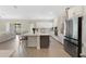 Open-concept kitchen showcases a center island, stainless steel appliances, and seamless flow to the living area at 19334 Banfield Pl, Orlando, FL 32827
