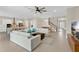 Open-concept living area with ample seating, modern ceiling fan, and an adjacent dining area at 19334 Banfield Pl, Orlando, FL 32827