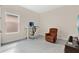 Cozy living room with neutral walls, gray tile floors, computer desk, and a recliner at 19334 Banfield Pl, Orlando, FL 32827