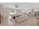 Bright open-concept living room features seamless flow to the kitchen and access to outdoor living space at 19334 Banfield Pl, Orlando, FL 32827