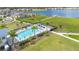 Community pool offers plenty of seating areas and sun umbrellas with a view of the lake and community amenities at 19334 Banfield Pl, Orlando, FL 32827