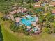 Beautiful aerial view of a resort-style community pool and clubhouse surrounded by lush tropical landscaping at 1945 Via Lago Dr, Lakeland, FL 33810