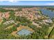 Beautiful aerial view showcasing the community's tennis courts and well-maintained landscaping with lake views at 1945 Via Lago Dr, Lakeland, FL 33810