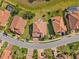 Bird's-eye view of houses with terracotta roofs and manicured lawns in a Gathering-friendly neighborhood at 1945 Via Lago Dr, Lakeland, FL 33810
