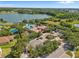 Community with a lake view, clubhouse, and pool surrounded by lush landscaping, creating a resort-like atmosphere at 1945 Via Lago Dr, Lakeland, FL 33810