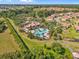 Beautiful aerial view of community pool and clubhouse surrounded by lush landscaping and well-maintained homes at 1945 Via Lago Dr, Lakeland, FL 33810
