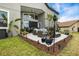 Beautiful backyard patio with seating, barbecue grill, and elegant landscaping at 1945 Via Lago Dr, Lakeland, FL 33810