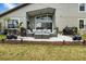 Spacious patio with an outdoor seating area, a barbecue grill, and lush landscaping at 1945 Via Lago Dr, Lakeland, FL 33810